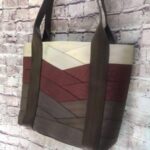 large tote hanging against brick wall