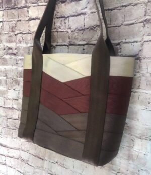large tote hanging against brick wall