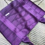 purple seat belt bag laying on table