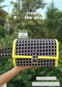 hand holding a navy and yellow rollie pollie organizer